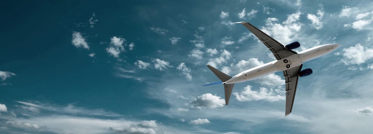 Airplane at fly on the sky with clouds