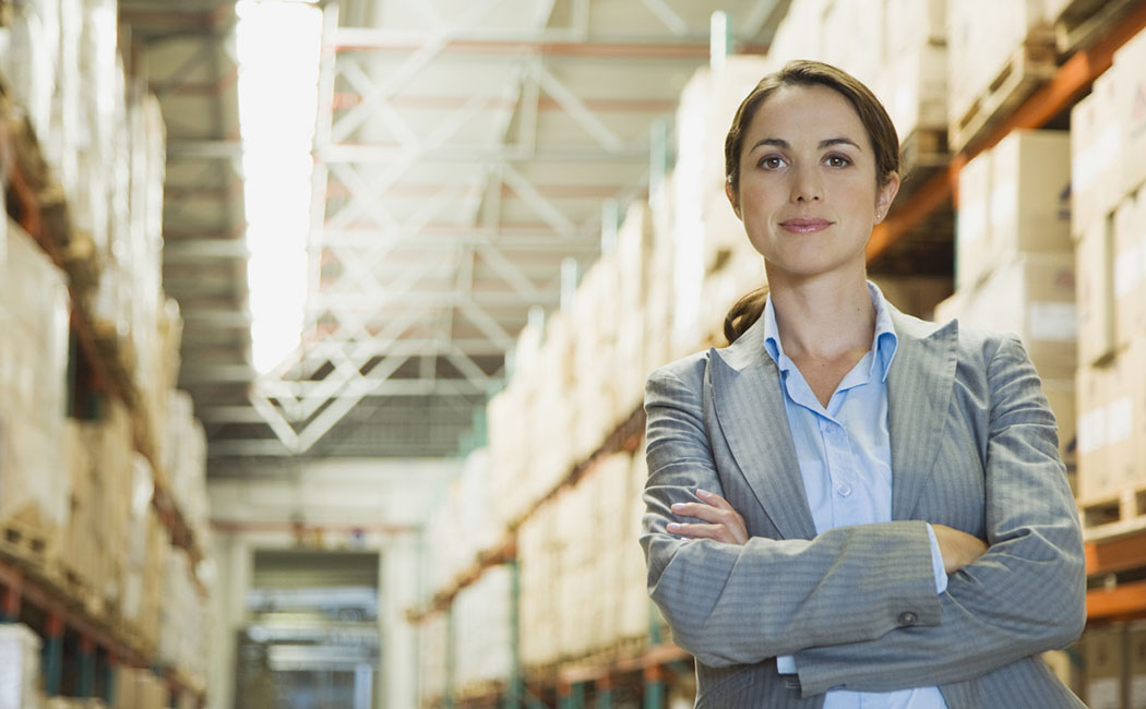 female executive standing in warehouse