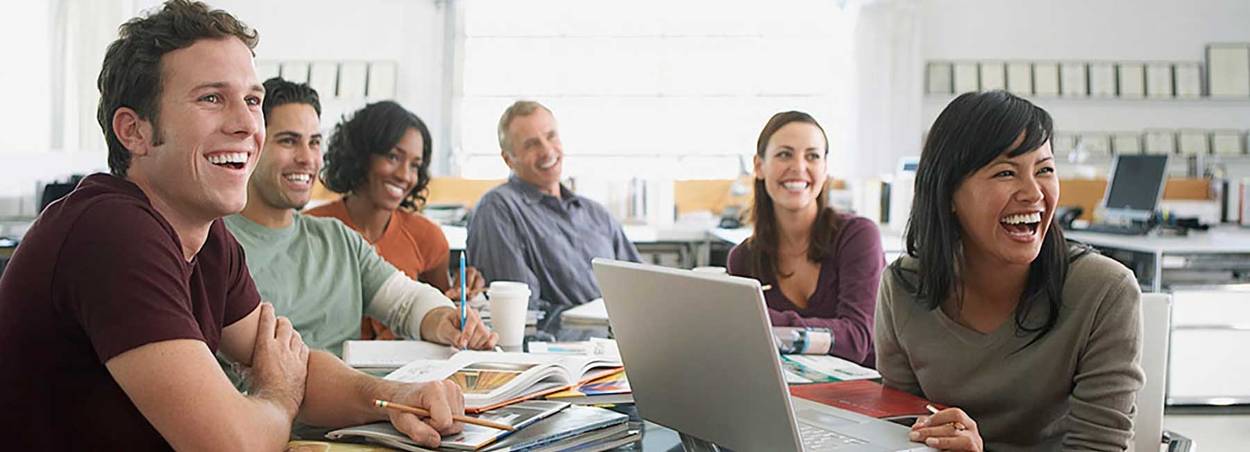 smiling and laughing workers at a meeting, AWS | DXC Technology