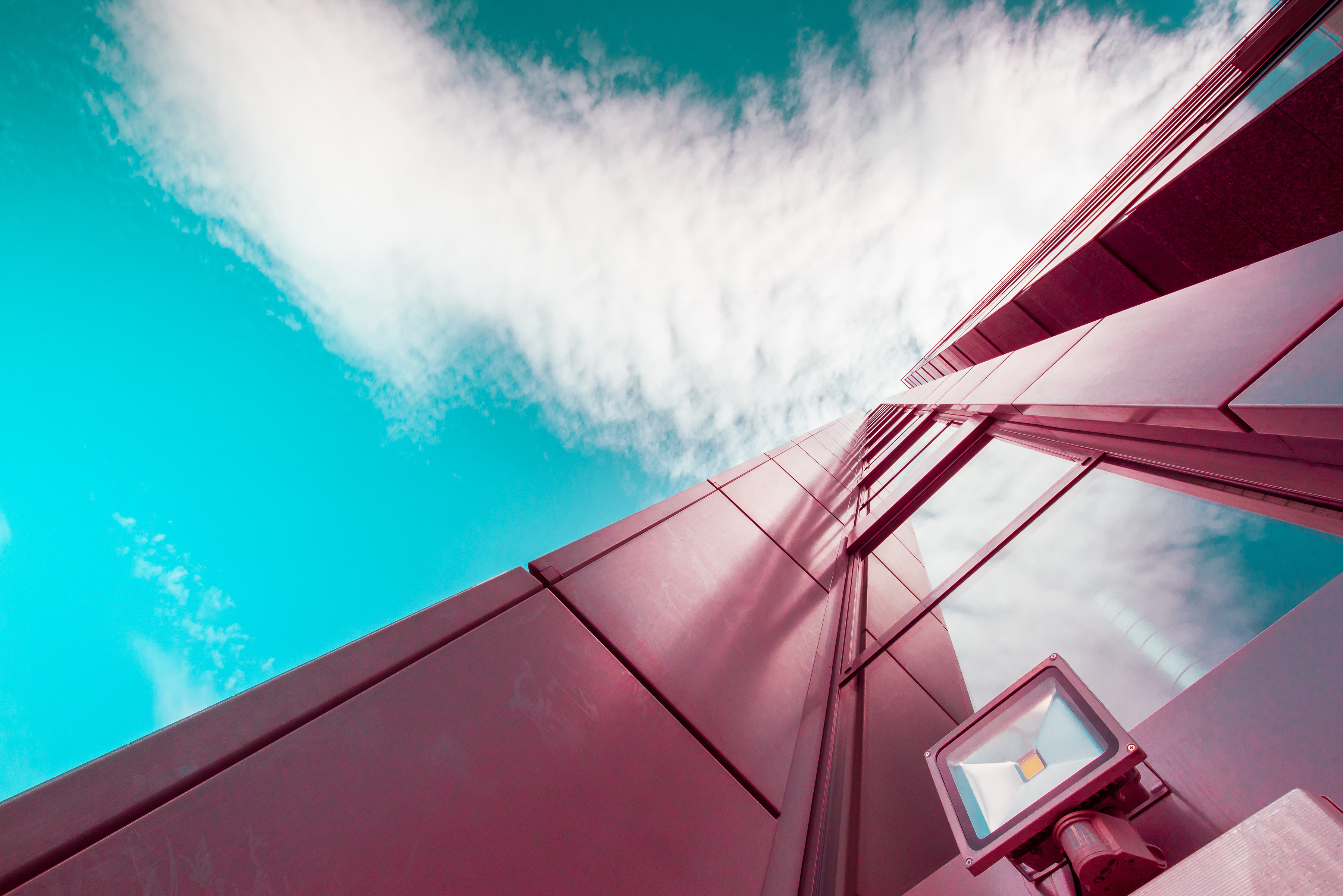 Purple building with security light against bright sky with cloud, Private Cloud | DXC Technology