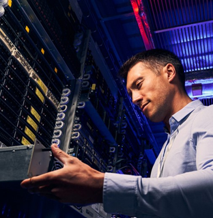 mainframe modernization represented by IT employee working in data center| DXC Technology Insights