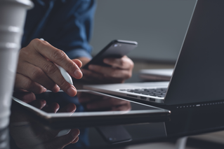 man working on desktop, tablet, phone, Modern Device Management | DXC Technology