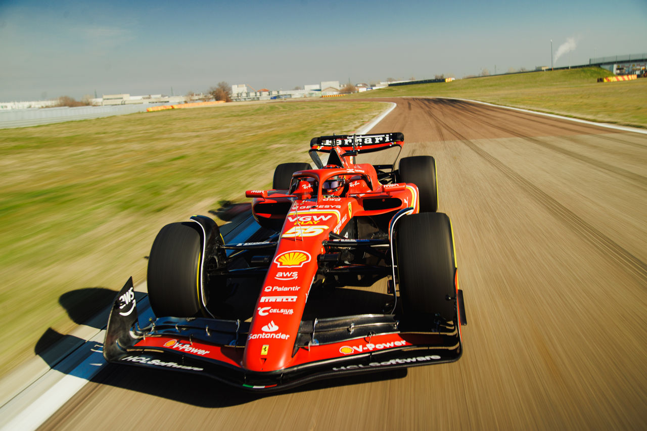 f1 driver climbing into car