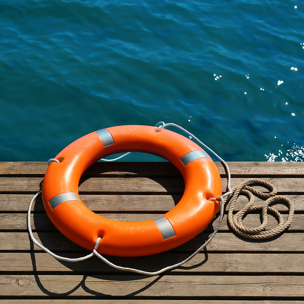 Lifebuoy ring on sea pier with space for text