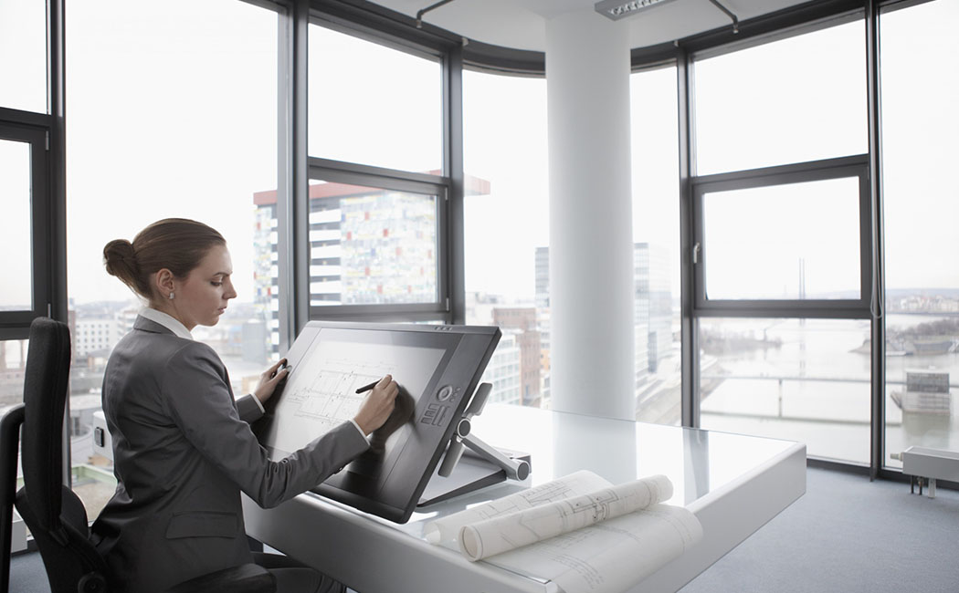 Architect working on digital tablet --- Image by © John Smith/Corbis