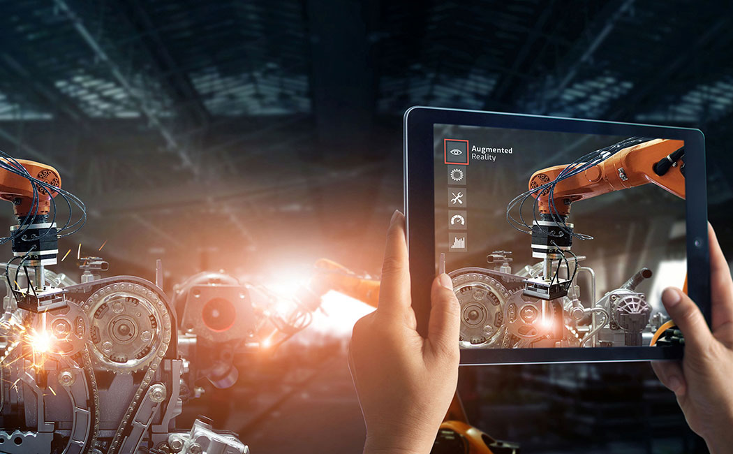 Augmented reality industry concept. Hand holding digital tablet use AR application to check and control welding robotics automatic arms machine in intelligent factory automotive industrial with monitoring system software. Digital manufacturing operation. Industry 4.0