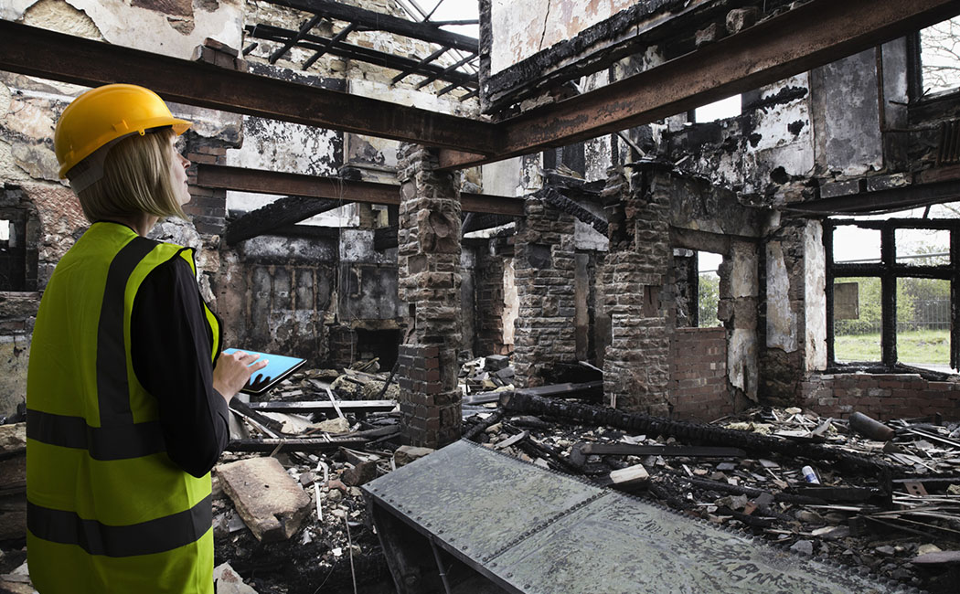 Insurance assessor inside fire damaged property