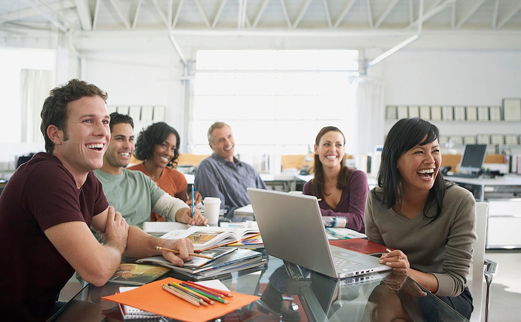 Happy office workers in conference room, AWS | DXC Technology