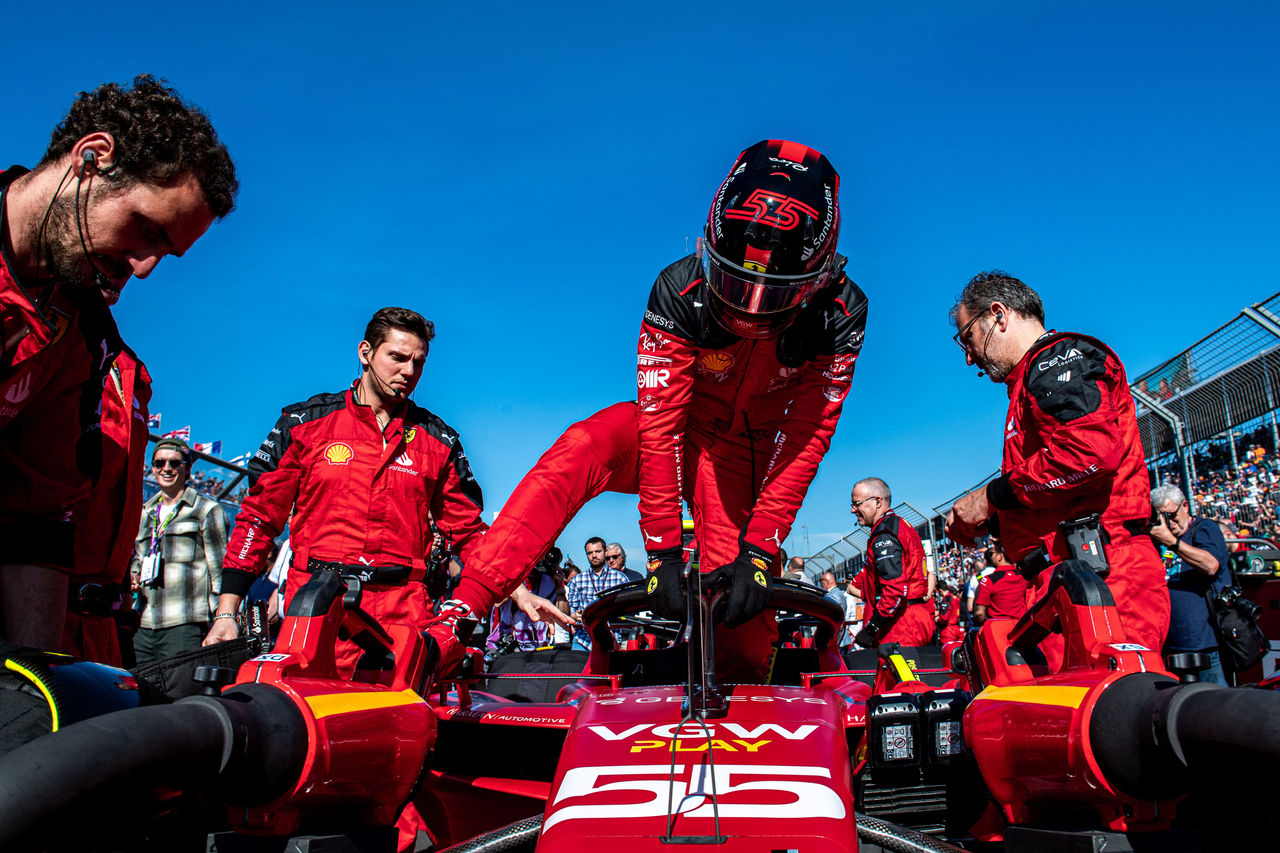 Ferrari racer climbing into racecar surrounded by cockpit crew, Asset Management | DXC Technology Insights
