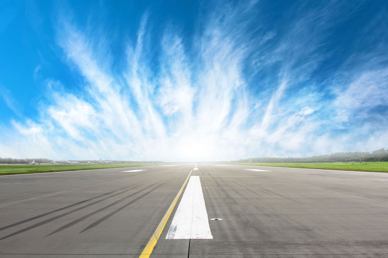 Empty runway strip with markings with beautiful clouds on the horizon