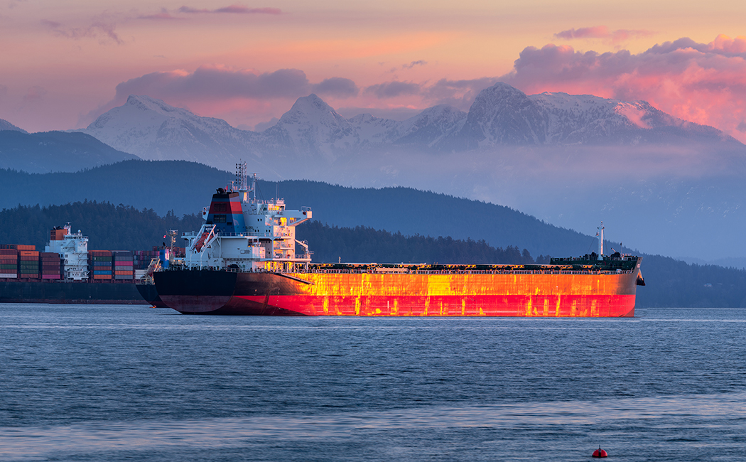 Large orange barge at sea, Assure Commercial and Specialty, Global Specialty | DXC Technology